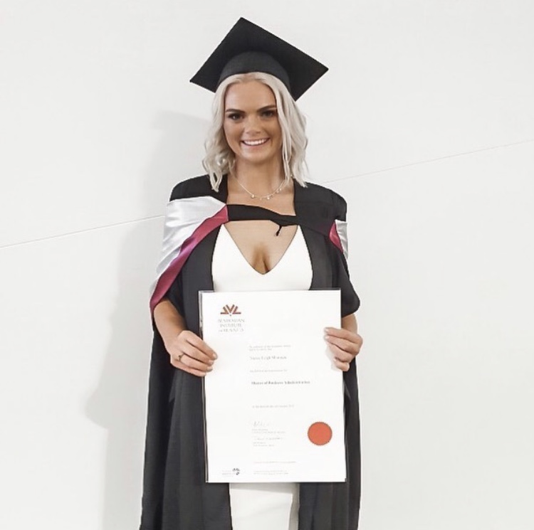 Stevie-Leigh in graduation atire holding her completed Master of Business Administration (MBA) in 2019.